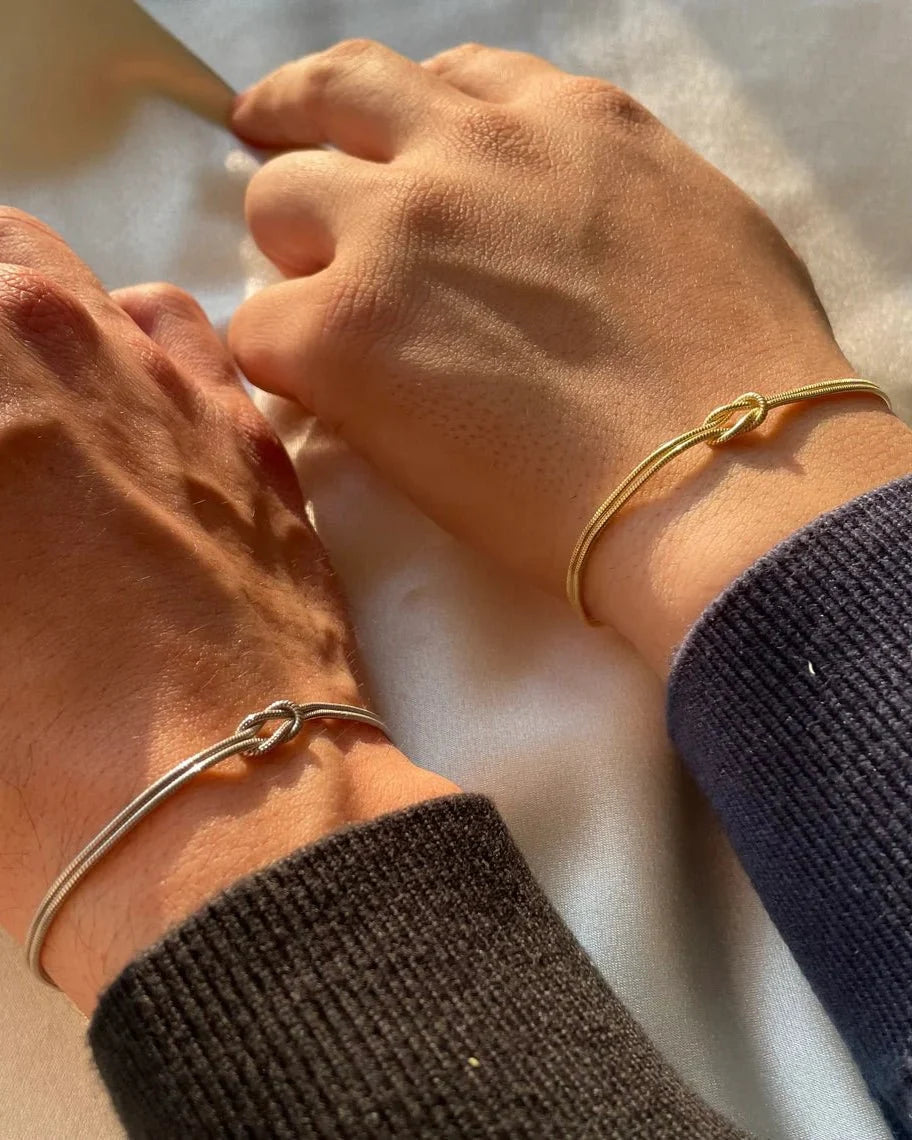 Forever Knot Bracelets in Gold and Silver, worn together