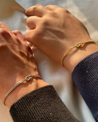 Forever Knot Bracelets in Gold and Silver, worn together