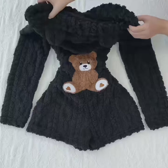 Product demonstration of the Cozy Bear hooded plush romper, showing the front zipper, textured fabric and teddy bear applique on the back.