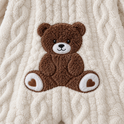 Close-up of the brown teddy bear applique on the back of the white Cozy Bear romper