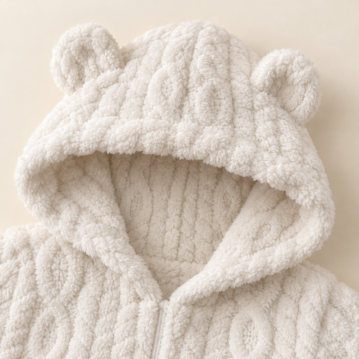 Close-up of the white Cozy Bear romper hood with two rounded bear ears